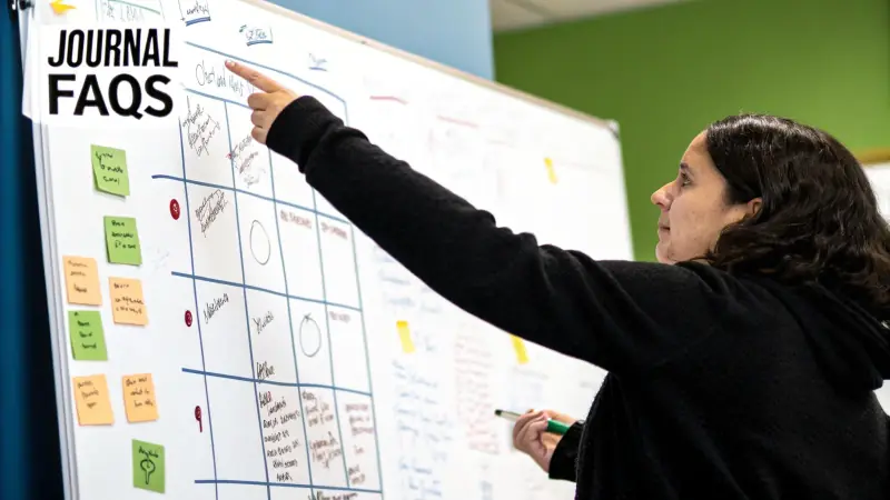 A trader looking thoughtfully at a computer screen showing an Excel spreadsheet.